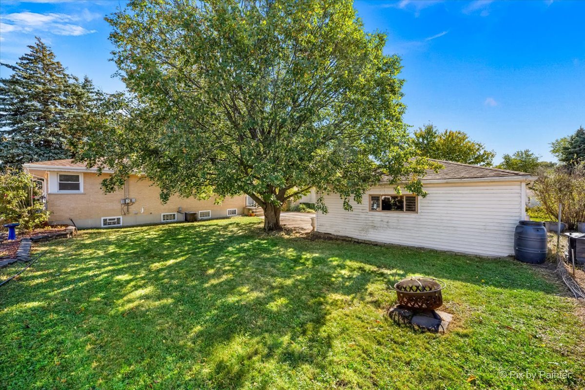 970 Fischer Drive Addison, IL 60101 - Photo 30 of 32 a backyard of a house with table and chairs