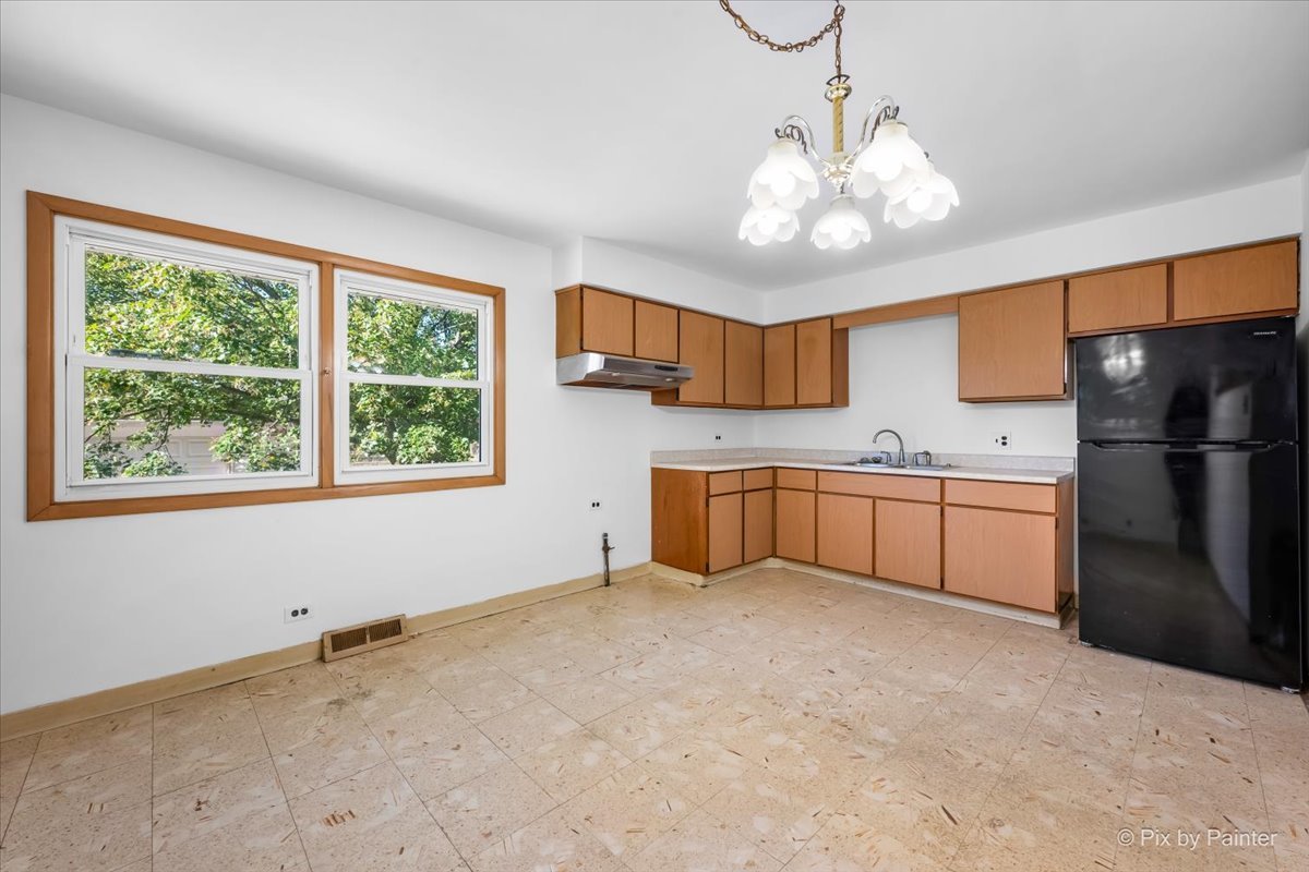 970 Fischer Drive Addison, IL 60101 - Photo 3 of 32 a kitchen with stainless steel appliances a refrigerator sink and cabinets