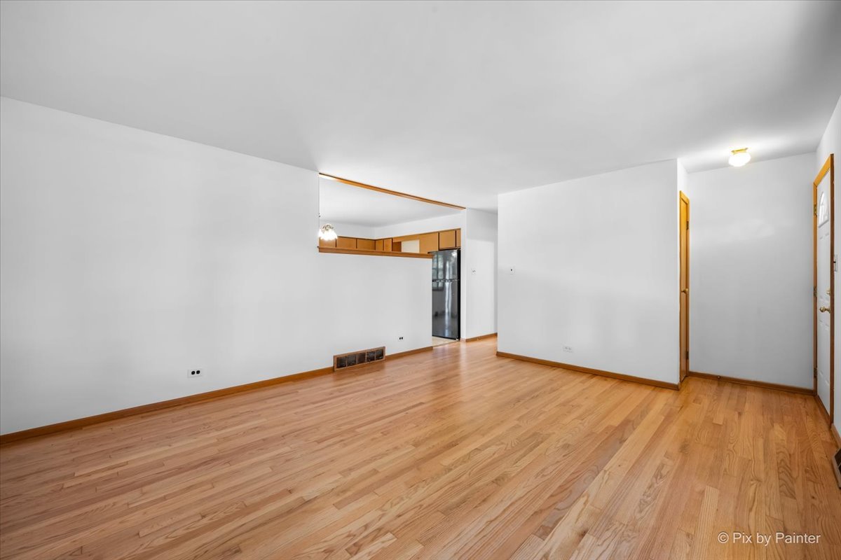 970 Fischer Drive Addison, IL 60101 - Photo 5 of 32 a view of an empty room with wooden floor