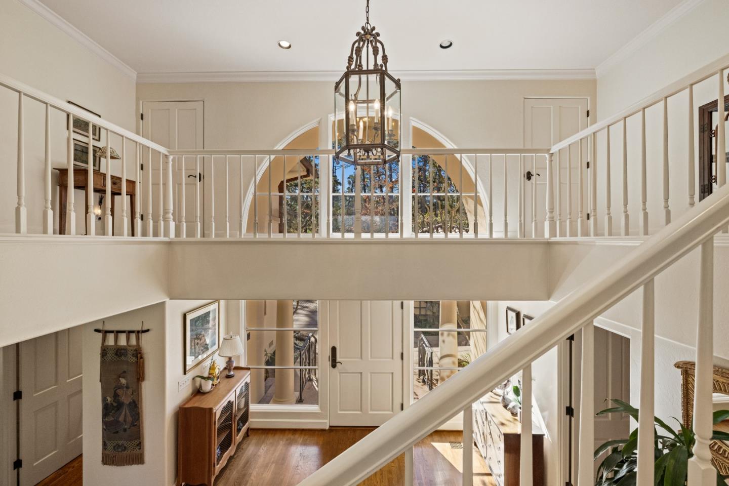 1221 Benbow Place Pebble Beach, CA 93953 - Photo 22 of 39 a view of a hallway with wooden floor and staircase