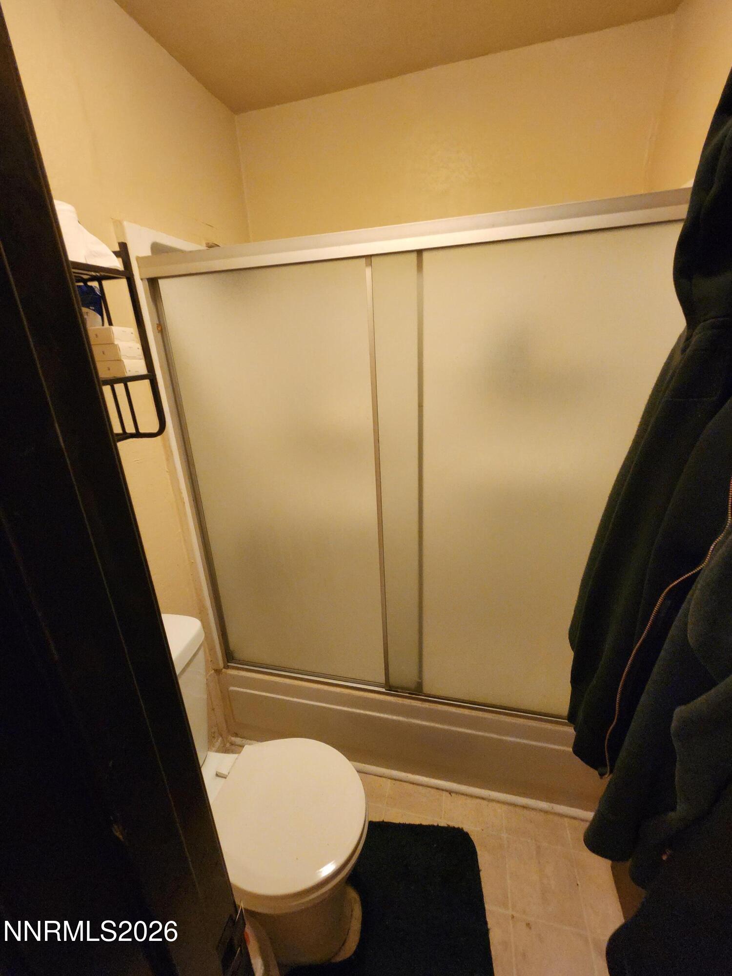 2450 Lymbery Street, Unit 211 Reno, NV 89509 - Photo 8 of 14 a bathroom with a granite countertop sink toilet and shower