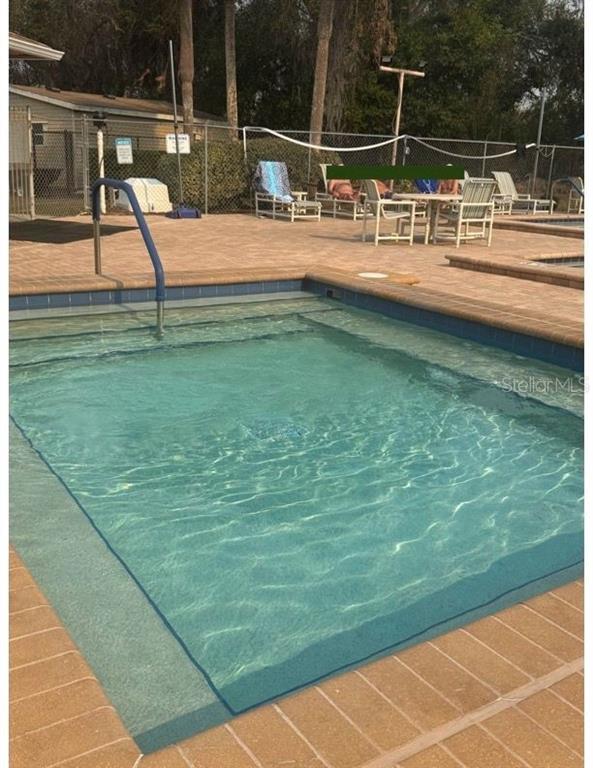 6334 Spring Flower Drive, Unit 14 New Port Richey, FL 34653 - Photo 23 of 25 a view of a swimming pool with a lawn chairs