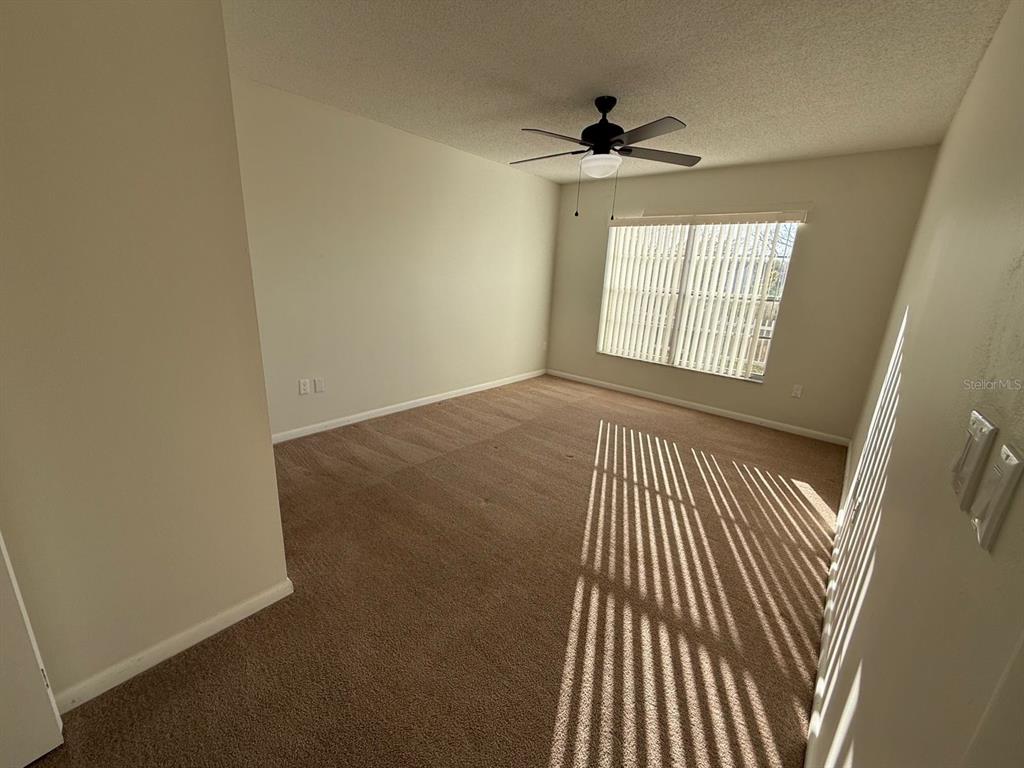 6334 Spring Flower Drive, Unit 14 New Port Richey, FL 34653 - Photo 8 of 25 a view of an empty room with wooden floor and a window