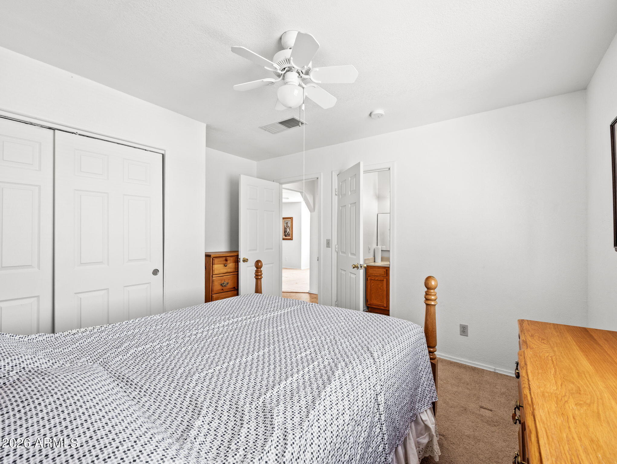 18420 Peeples Valley Road Peeples Valley, AZ 86332 - Photo 20 of 31 a bedroom with a large bed and a chandelier