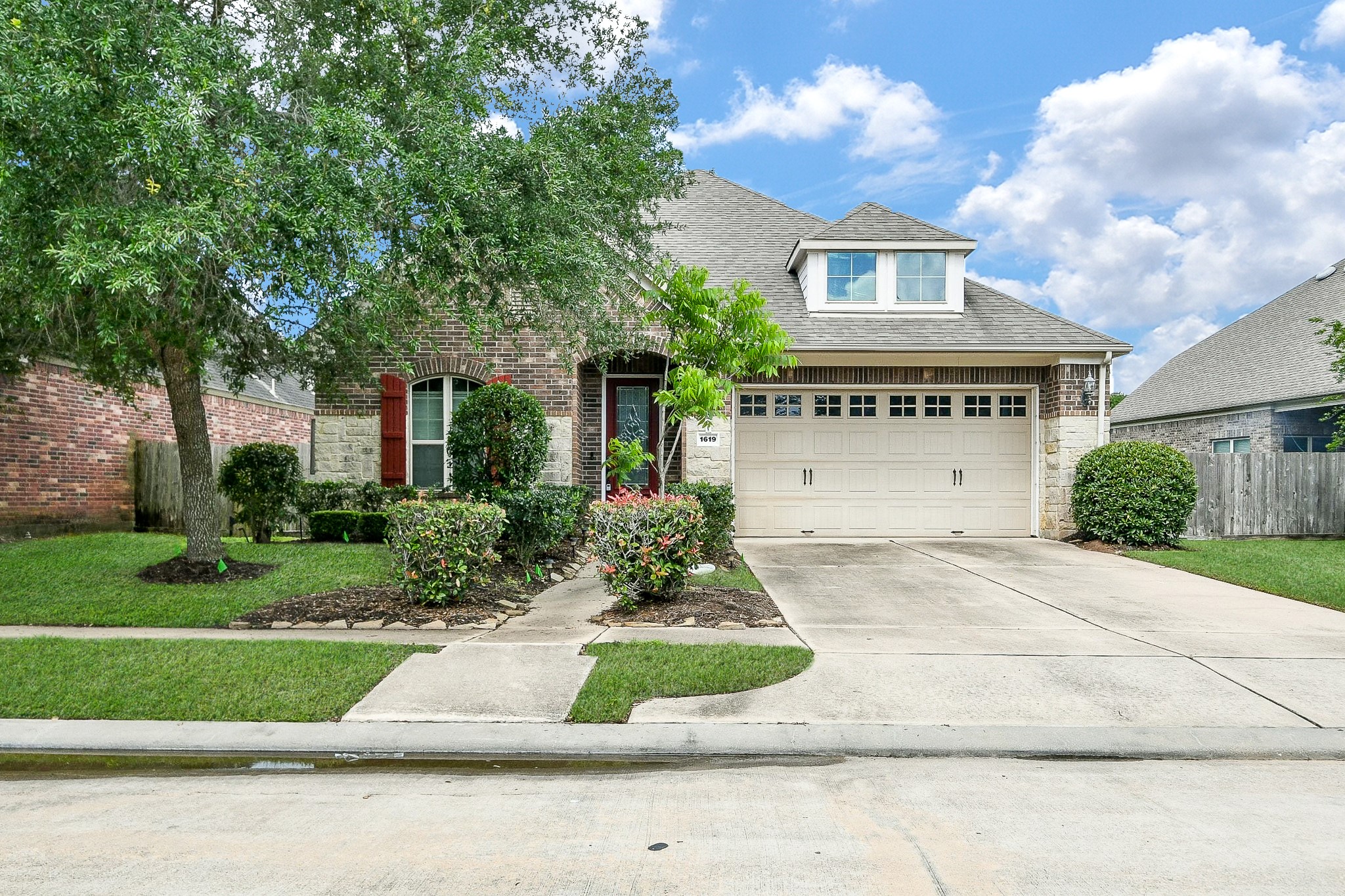 1619 Ralston Branch Way Sugar Land, TX 77479 - Photo 1 of 20 a front view of a house with a yard and garage