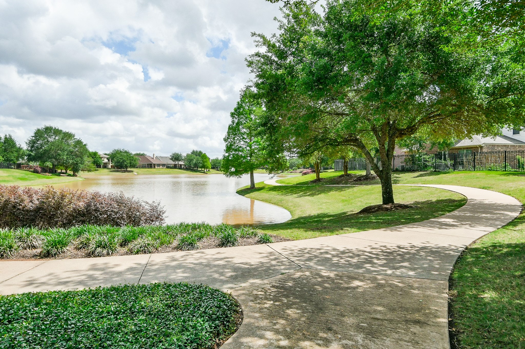 1619 Ralston Branch Way Sugar Land, TX 77479 - Photo 20 of 20 a view of a lake with a yard and large trees