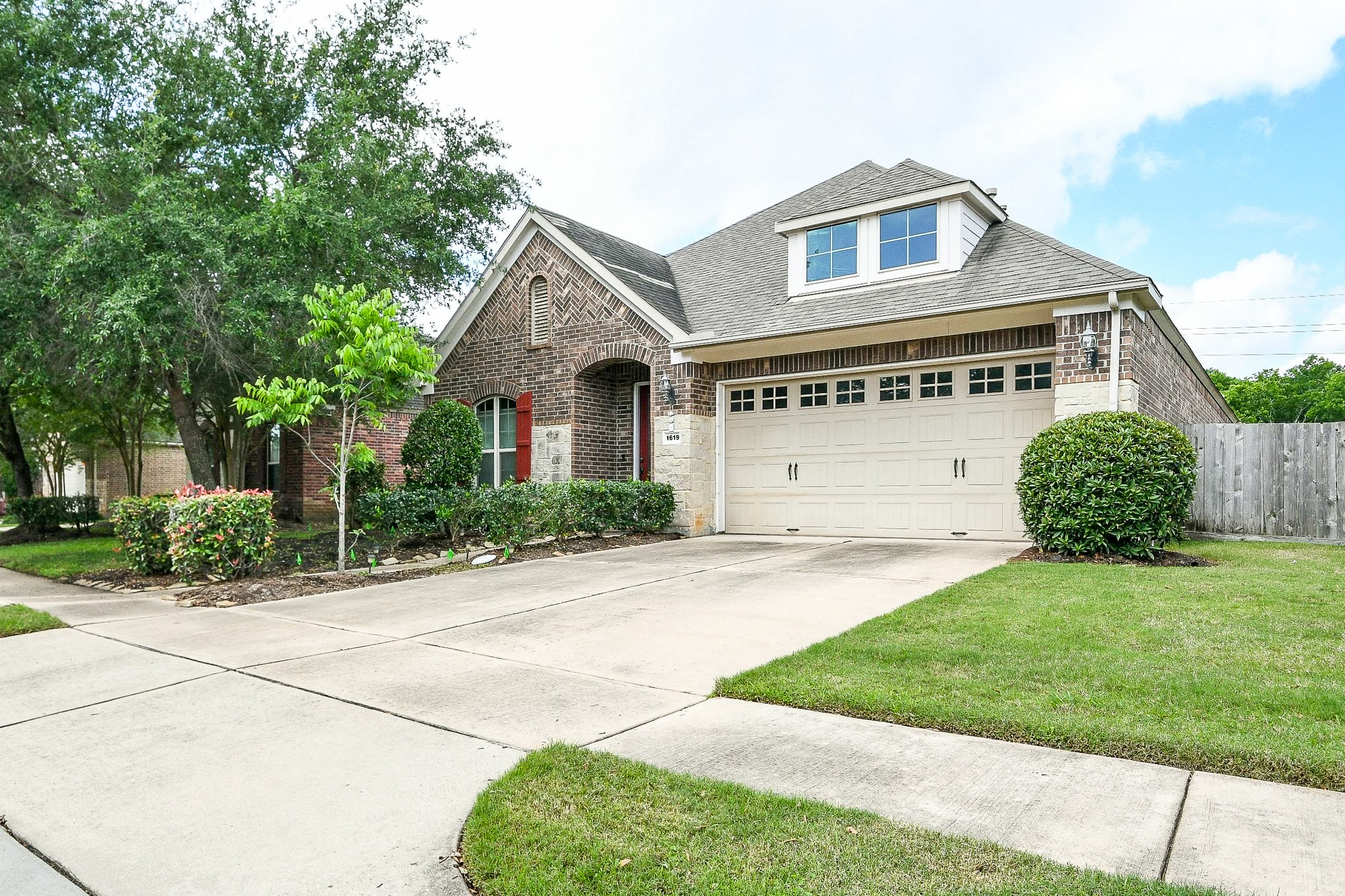 1619 Ralston Branch Way Sugar Land, TX 77479 - Photo 2 of 20 a front view of a house with a yard and garage