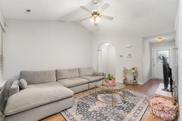 a living room with furniture a rug and a chandelier
