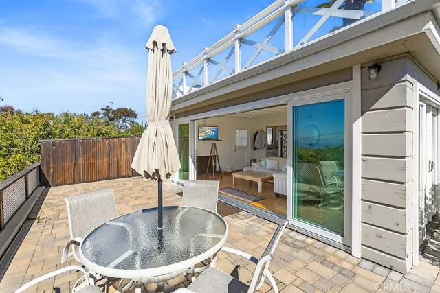 a roof deck with table and chairs