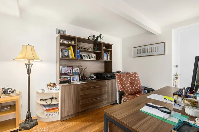 a bedroom with furniture and a wooden floor