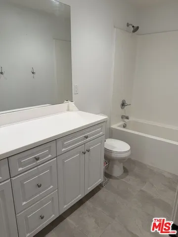 a spacious bathroom with a toilet a sink and a bathtub