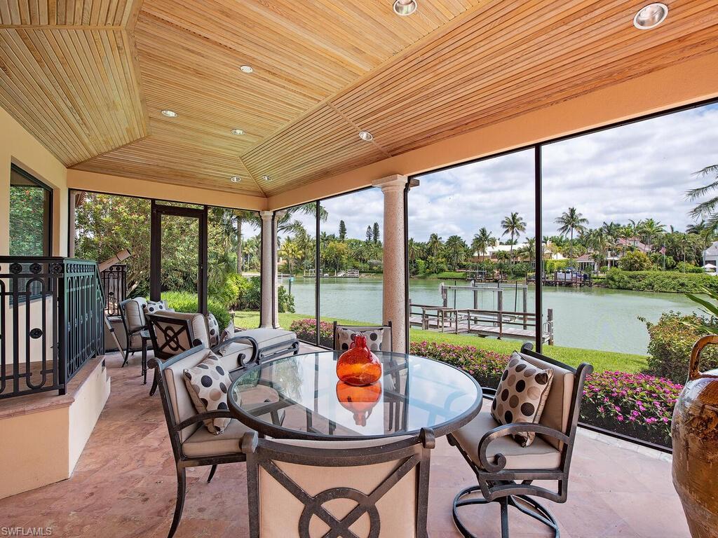 3133 Rum Row Naples, FL 34102 - Photo 13 of 35 a dining room with furniture water view and pool table and chairs