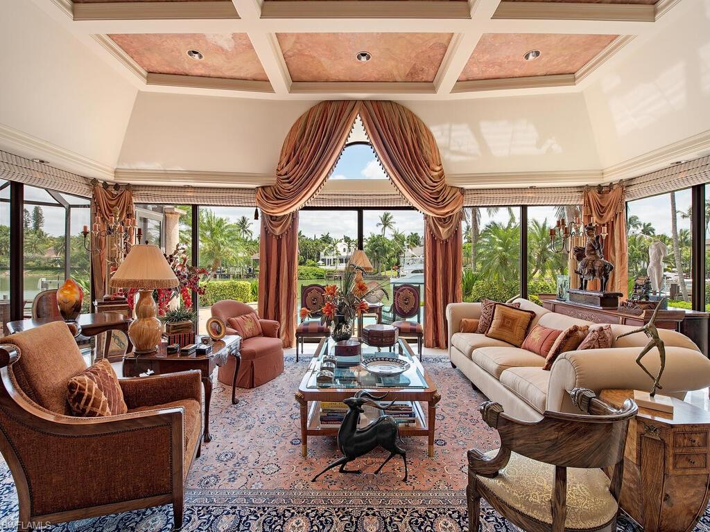 3133 Rum Row Naples, FL 34102 - Photo 15 of 35 a living room with furniture and a large window