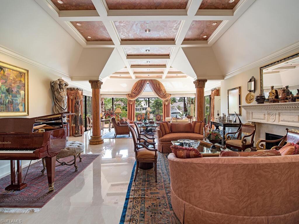 3133 Rum Row Naples, FL 34102 - Photo 16 of 35 a living room with lots of furniture and a large window