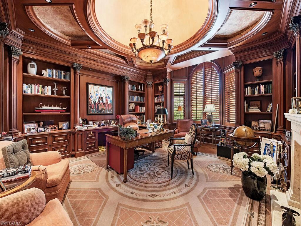 3133 Rum Row Naples, FL 34102 - Photo 17 of 35 a living room with fireplace furniture and a chandelier