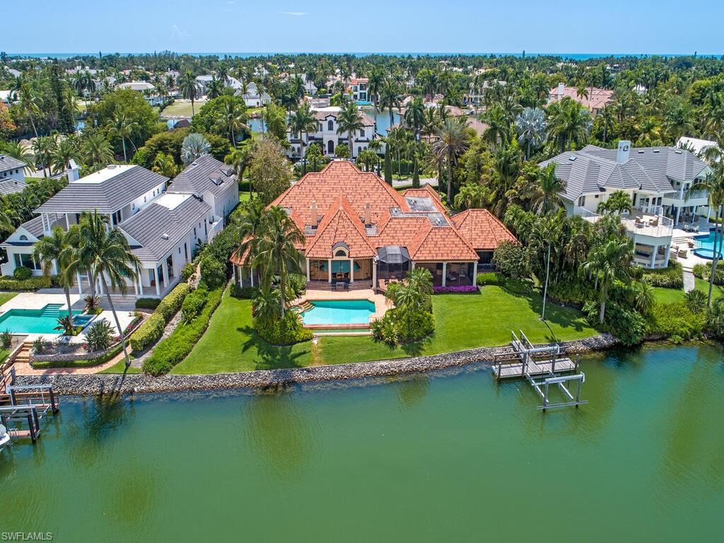 3133 Rum Row Naples, FL 34102 - Photo 2 of 35 an aerial view of a house with a garden and lake view