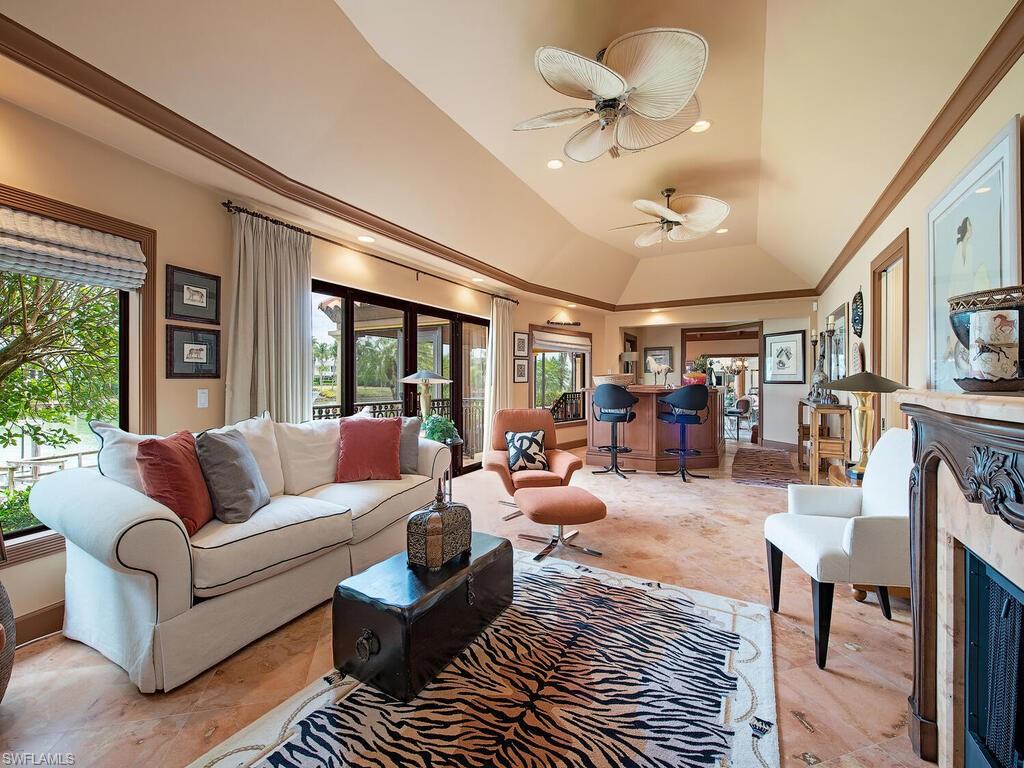 3133 Rum Row Naples, FL 34102 - Photo 21 of 35 a living room with furniture ceiling fan and a rug