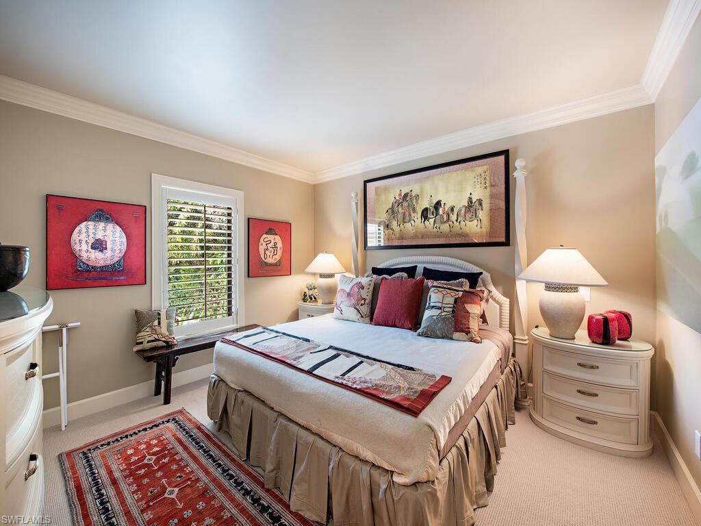 3133 Rum Row Naples, FL 34102 - Photo 26 of 35 a bedroom with a bed and a dresser in it