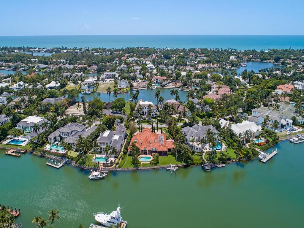 3133 Rum Row Naples, FL 34102 - Photo 29 of 35 an aerial view of residential houses with outdoor space and trees all around