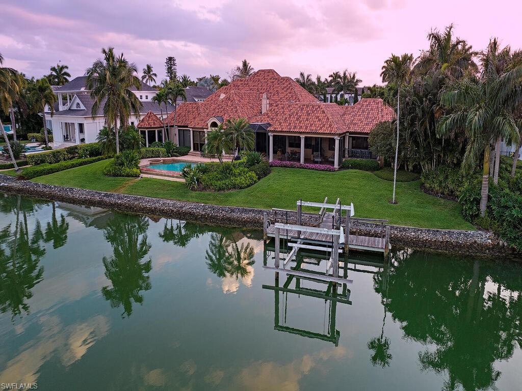 3133 Rum Row Naples, FL 34102 - Photo 35 of 35 a view of a lake with a house in the background