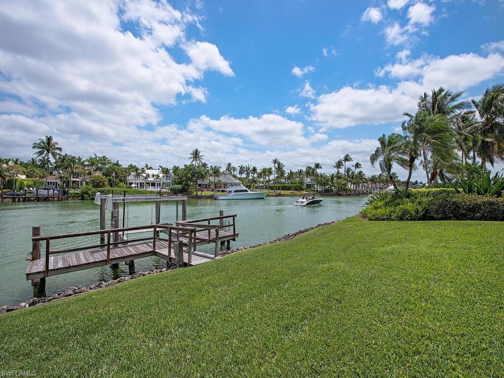 3133 Rum Row Naples, FL 34102 - Photo 8 of 35 a view of a lake with houses in the back
