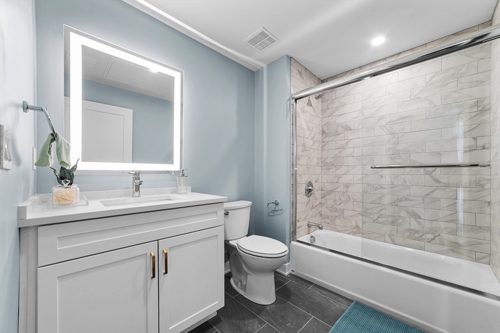 500 Talbot Avenue, Unit 403 Boston, MA 02124 - Photo 9 of 25 a bathroom with a sink toilet vanity and shower