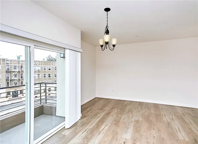 a view of a room with wooden floor and windows