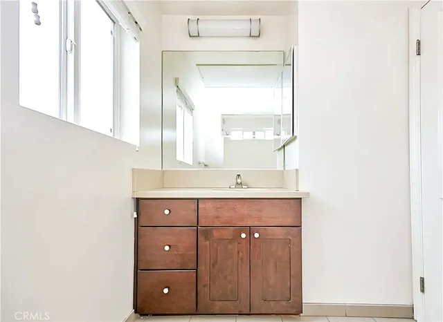 a bathroom with a sink vanity and a mirror