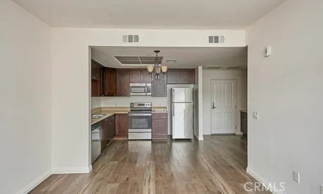 a kitchen with stainless steel appliances a sink and a refrigerator