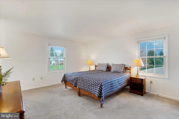 a bedroom with a bed and a lamp on table
