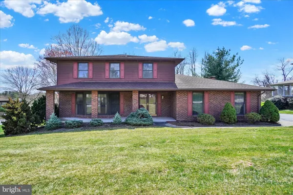 a view of a brick house with a yard