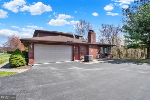 a view of a house with a yard and garage
