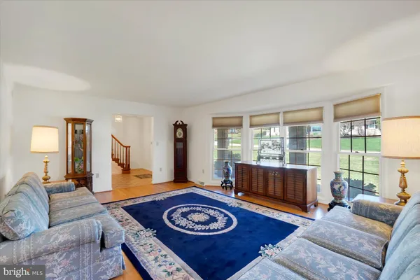a dining room with furniture a rug and wooden floor