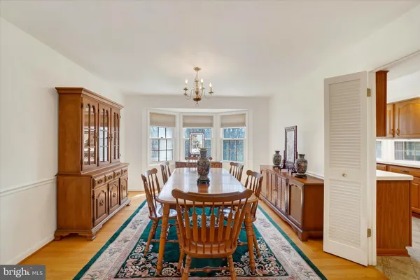 a view of a dining room with furniture and chandelier