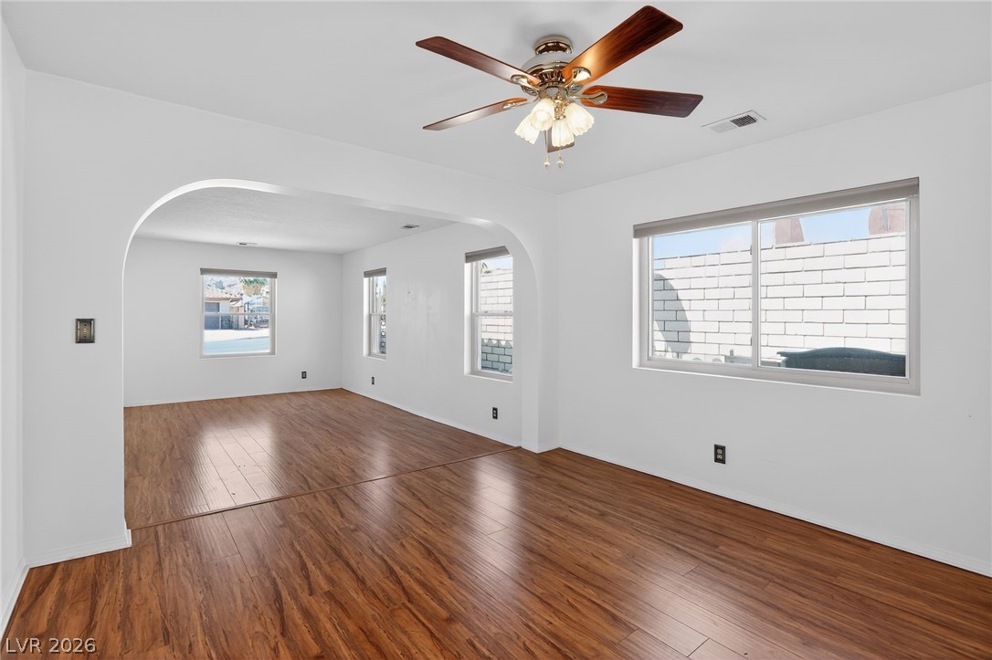 3698 Laughlin Boulevard Laughlin, NV 89029 - Photo 16 of 49 Rich hardwood floors flow through an airy living space with an elegant arched doorway and abundant natural light.
