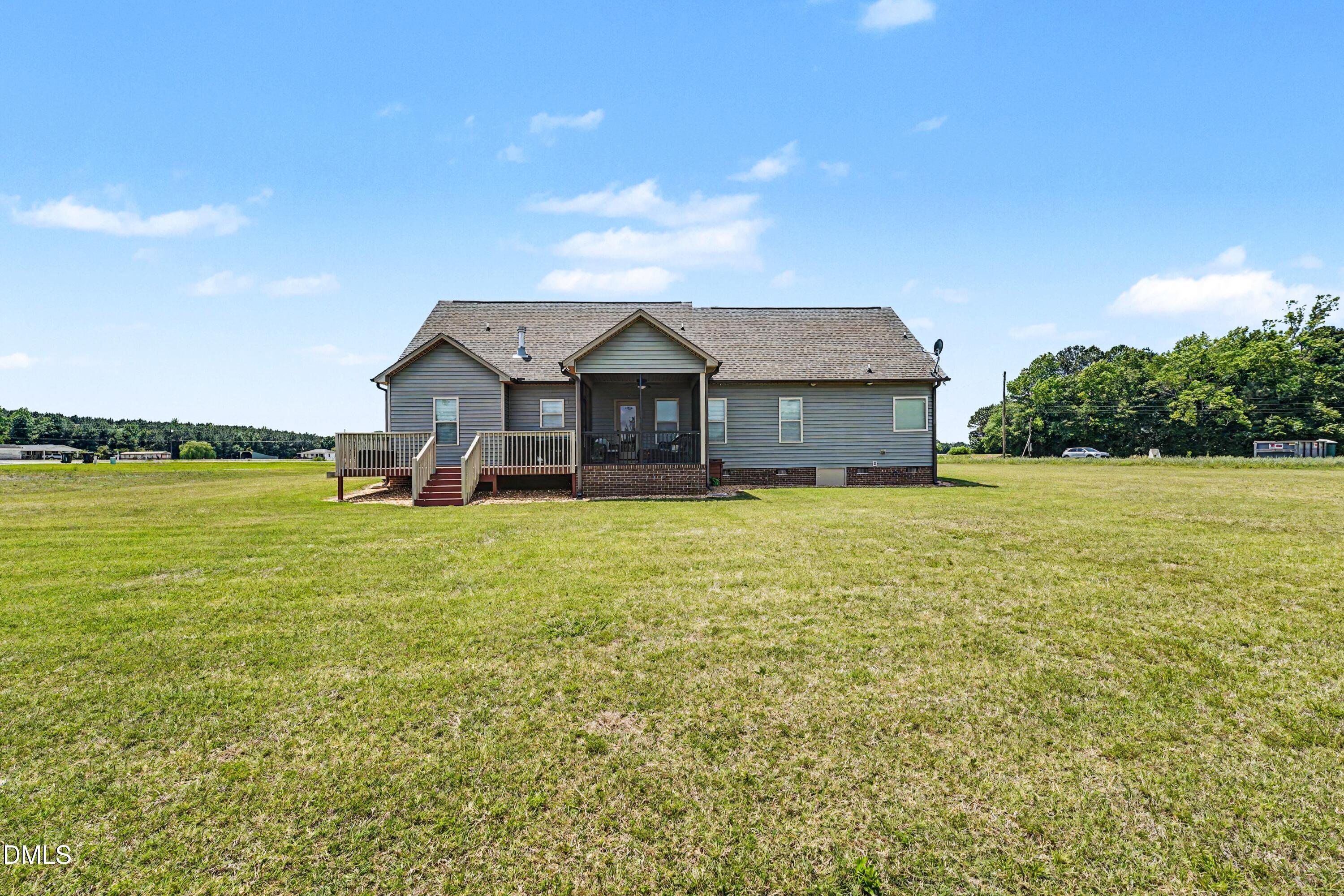 3587 Hannah Creek Road Benson, NC 27504 - Photo 33 of 43 a front view of a house with a garden and lake view