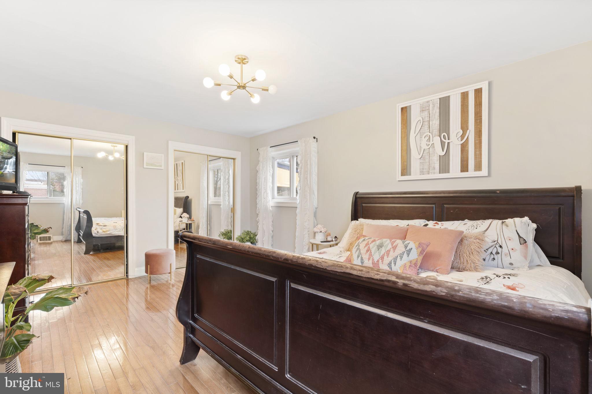 201 Juniper Road Havertown, PA 19083 - Photo 13 of 30 a bedroom with a large bed and a chandelier