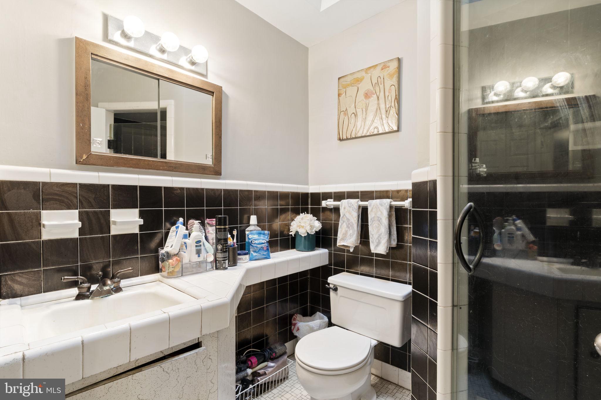 201 Juniper Road Havertown, PA 19083 - Photo 14 of 30 a bathroom with a toilet sink and mirror