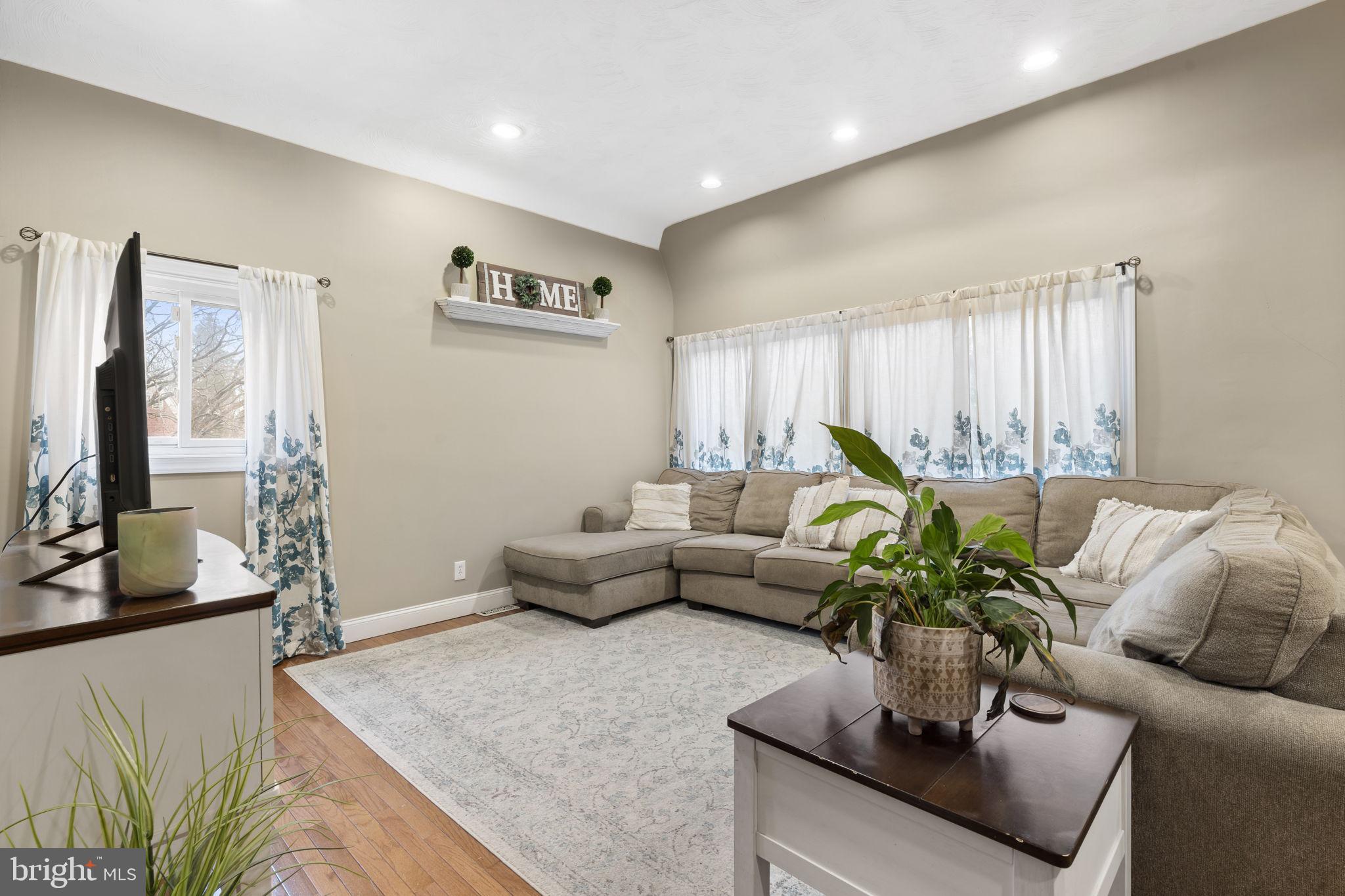 201 Juniper Road Havertown, PA 19083 - Photo 4 of 30 a living room with furniture potted plant and a large window