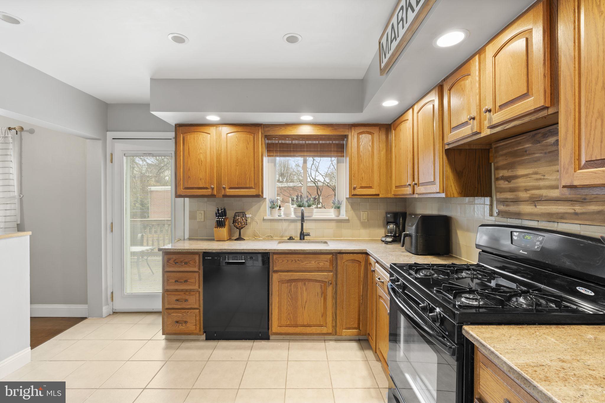 201 Juniper Road Havertown, PA 19083 - Photo 7 of 30 a kitchen with a sink stove top oven and cabinets