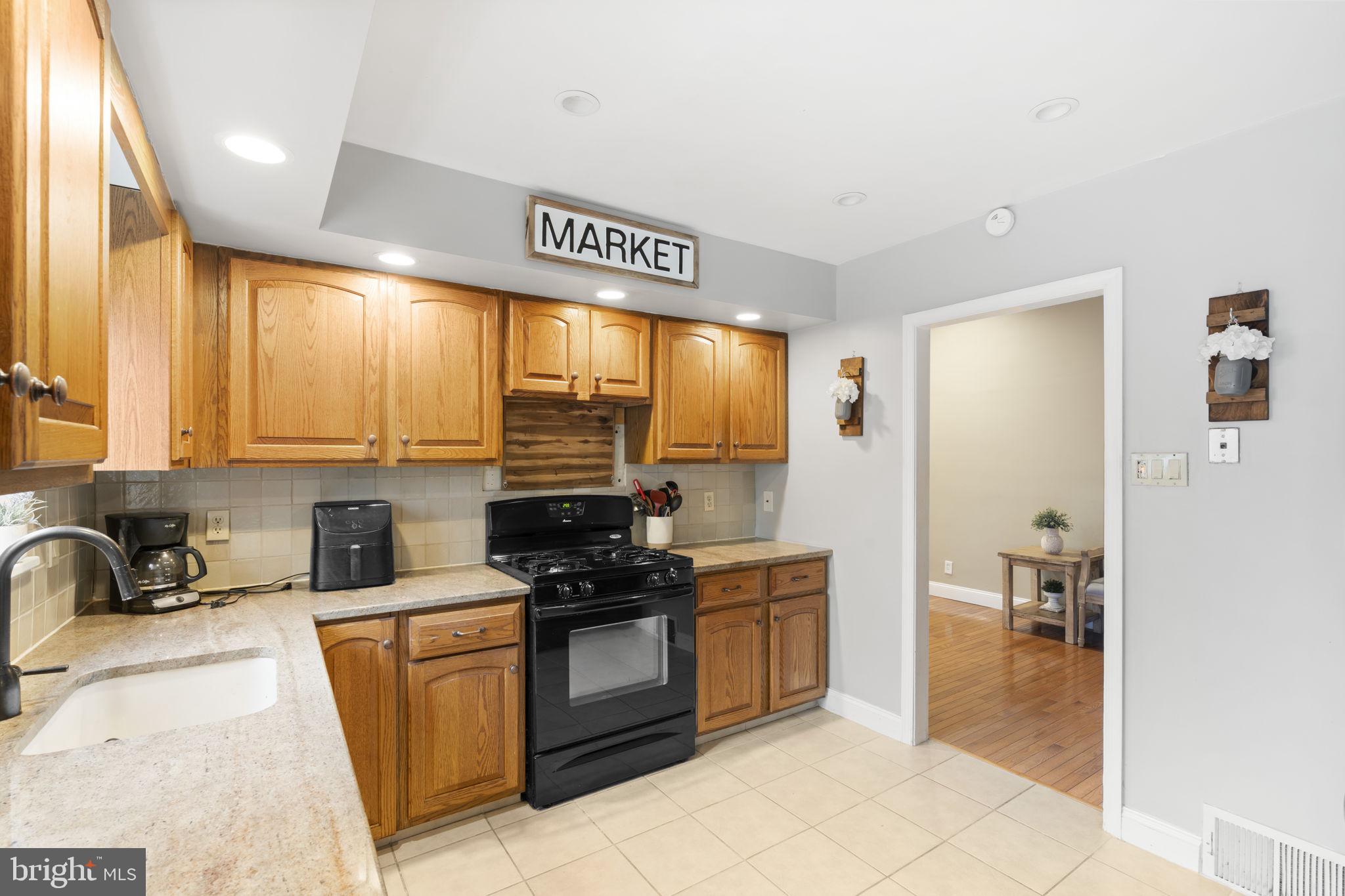 201 Juniper Road Havertown, PA 19083 - Photo 8 of 30 a kitchen with stainless steel appliances granite countertop a stove sink and cabinets