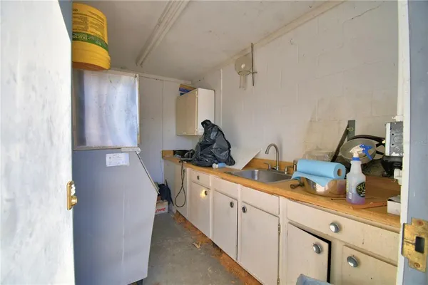 a kitchen with a sink and a refrigerator