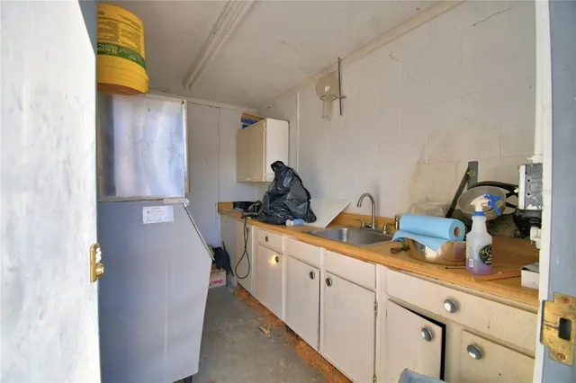 a kitchen with a sink and a refrigerator