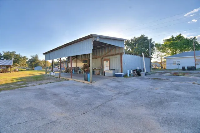 a view of a house with backyard and a patio