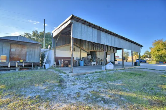 a view of a house with a yard and sitting area