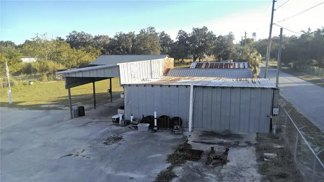 a view of a chairs and table in the backyard