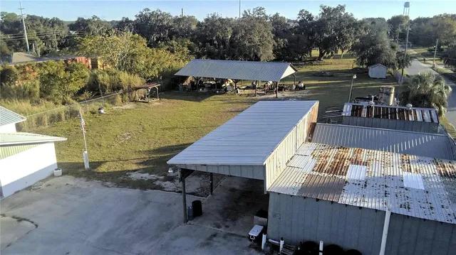 a view of a patio with table and chairs a barbeque with wooden floor and fence