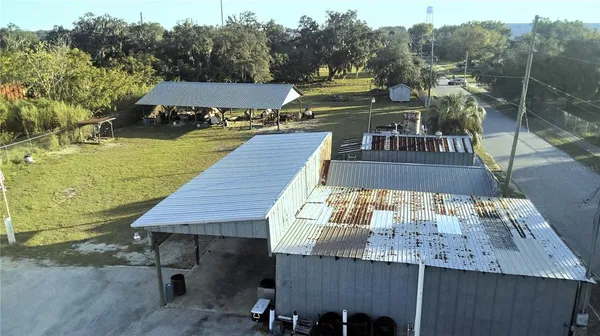 a view of a patio with table and chairs with wooden floor and fence
