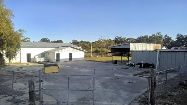 a view of a house with a yard and sitting area