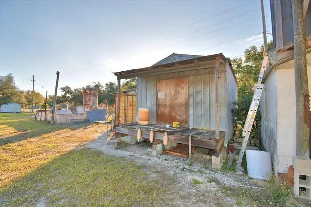a view of a house with backyard porch and sitting area